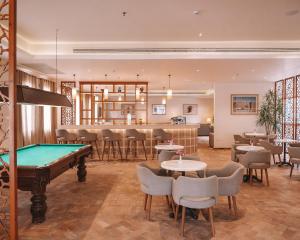 a billiard room with a pool table and a bar at Fort Arabesque Resort, Spa & Villas in Hurghada