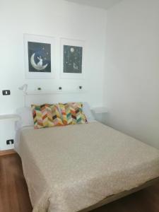 a bedroom with a bed and two pictures on the wall at Estudio Puntillo del Sol in Puntillo del Sol