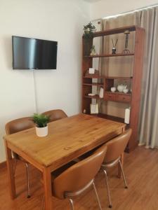 a dining room table with chairs and a television at Estudio Puntillo del Sol in Puntillo del Sol +5 photos