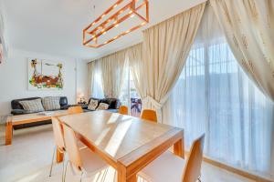 a living room with a wooden table and chairs at Penthouse Apartment in Elviria in Marbella