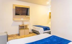 Postel nebo postele na pokoji v ubytování Hotel Salinero - Zipaquirá