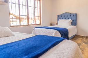 Postel nebo postele na pokoji v ubytování Hotel Salinero - Zipaquirá