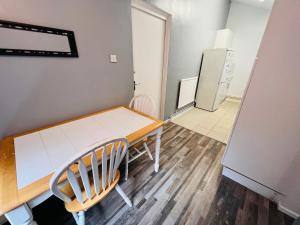 a small kitchen with a table and a refrigerator at Extra Large Double one Bedroom Rental Near Central London & Close to Transport in London
