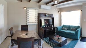 a living room with a blue couch and a table at ENTRE CISNES 1, 2 y 3 Dorm in Valdivia