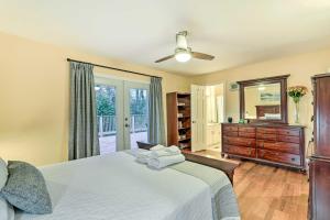 a bedroom with a bed and a dresser and a window at Atlanta Abode with Yard in a Tranquil Setting! in Norcross