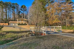 a house with a white fence on a road at Atlanta Abode with Yard in a Tranquil Setting! in Norcross