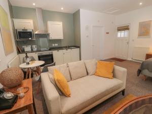 a living room with a couch and a kitchen at Cheviot View in Cornhill-on-tweed