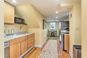 a kitchen with a sink and a refrigerator at Townhome in Leesburg Historic District! in Leesburg