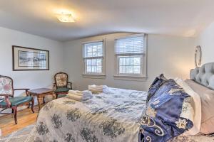 a bedroom with a bed and chairs and windows at Townhome in Leesburg Historic District! in Leesburg