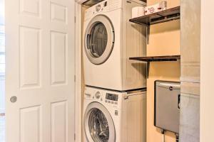 a laundry room with a washer and dryer next to a door at Townhome in Leesburg Historic District! in Leesburg