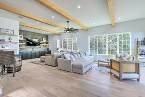 a living room with a couch and a tv at Luxury Lake Granbury Cliffside Home with Deck! in Granbury