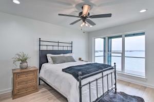 a bedroom with a bed and a ceiling fan at Luxury Lake Granbury Cliffside Home with Deck! in Granbury