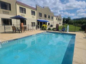 a large blue swimming pool in front of a building at Comfort Inn & Suites Leeds I-20 in Leeds