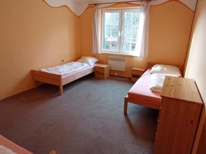 Postel nebo postele na pokoji v ubytování Bydlinská zahrádka Těšíkov
