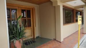 a house with a potted plant in front of a door at Hotel Casa del Arbol in San Pedro Sula