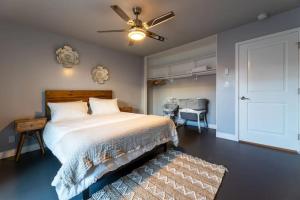 a bedroom with a bed and a ceiling fan at Modern San Pedro Home Sleeps 12 in San Pedro