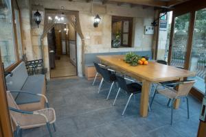 a dining room with a wooden table and chairs at Casa La Portilla a 6Km de Cabarceno WIFI in Esles +11 photos