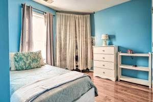 a bedroom with blue walls and a bed and a dresser at 5 Mi to National Mall Home in Washington DC in Washington
