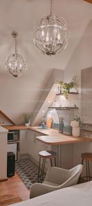 a kitchen with two lights and a counter with stools at Y Llofft - Cosy Country Retreat in the Brecon Beacons in Crickhowell +6 photos