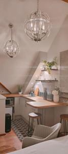 a kitchen with two lights and a counter with stools at Cosy Country Retreat in the Brecon Beacons in Crickhowell