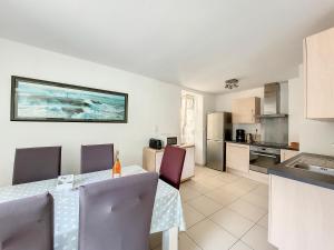 a kitchen and dining room with a table and chairs at Au Fil De L'eau - Les Remparts in Dinan +29 photos