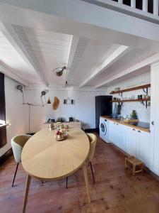 a kitchen with a table and chairs in a room at CASA YOOJ designers house in teguise in Teguise