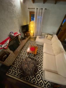 a living room with a white couch and a rug at Orino Livadi Mount Villa IV in Arachova