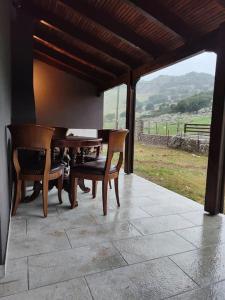 a table and chairs on a patio with a view at Orino Livadi Mount Villa IV in Arachova +14 photos