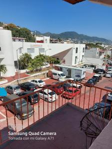a parking lot with cars parked in a parking lot at Hotel la Quebrada in Acapulco