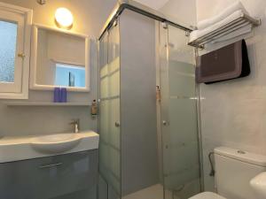 a bathroom with a shower and a sink and a toilet at Hotel Alexandra Sitges in Sitges