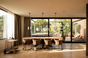 a dining room with a table and some chairs at Kimpton Aysla Mallorca by IHG in Santa Ponsa