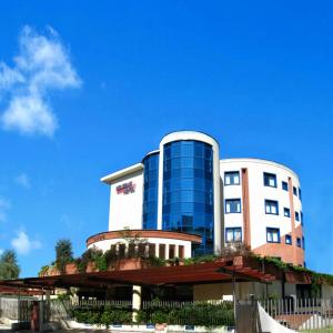 a building with a blue and white building at Welcome Hotel in Legnano