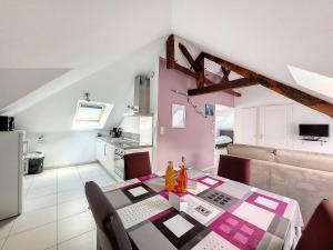 a kitchen and a dining room with a table and chairs at Au Fil De L'eau - Le Jerzual in Dinan