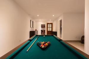 a pool table with a bowl of balls on it at Chalet Tiro del Pichón I in Marbella