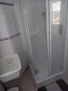a small bathroom with a shower and a toilet at T2 calme proche plage de Porcé in Saint-Nazaire
