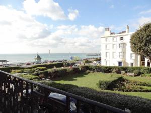 a view of a building with the ocean in the background at Regency Apartment - Marine Square By Crown Gardens Holiday Homes in Brighton & Hove