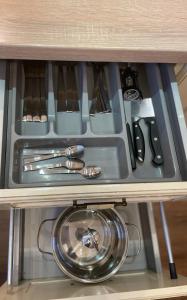 a drawer in a cabinet with utensils at Dviejų kambarių butas in Tauragė
