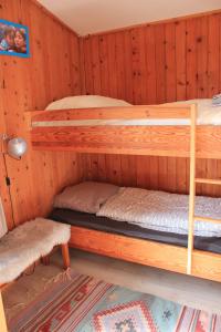 a bedroom with two bunk beds in a cabin at Le Clou in Thiézac