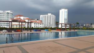 a large swimming pool in a city with tall buildings at Vista Alam Studio in Shah Alam