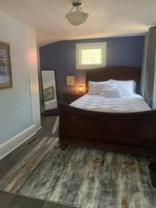 um quarto com uma cama grande e uma parede azul em Trip6 Historic Brick Home em Helena