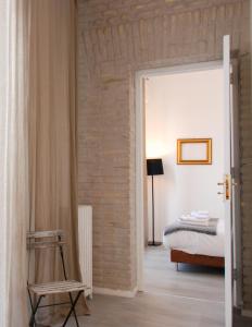 a bedroom with a bed and a door leading into a room at Loft Esquilino Terrazza a Stazione Termini in Rome