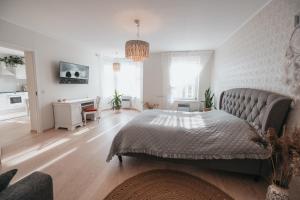 a bedroom with a bed and a living room at Rüütli 24-2 in Pärnu