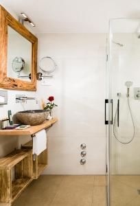 a bathroom with a sink and a shower at Berghotel Rehlegg in Ramsau