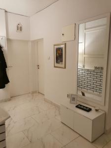 a kitchen with white walls and white tile floors at Apartment Deni in Pula