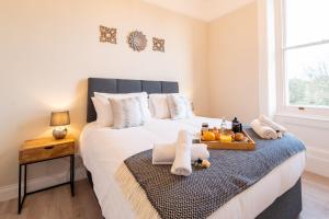 a bedroom with a bed with a tray of food on it at Stylish maisonette in town centre close to beach in Great Yarmouth