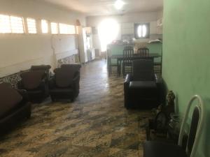 a living room with chairs and a table in a room at Casarão in Arapiraca