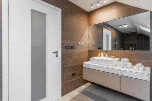 a bathroom with a sink and a mirror at ESCAPE THE ORDINARY (Sauna & Jacuzzi) in Jesenice