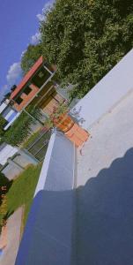 a reflection of a building with a tree and a house at Cabaña Milan in Aguachica +4 photos