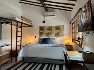 a bedroom with a bed and a loft bed at Casa Medallo Hotel Boutique in Medellín