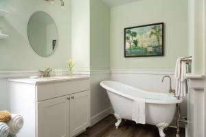 a white bathroom with a tub and a sink at The Grafton Inn in Grafton